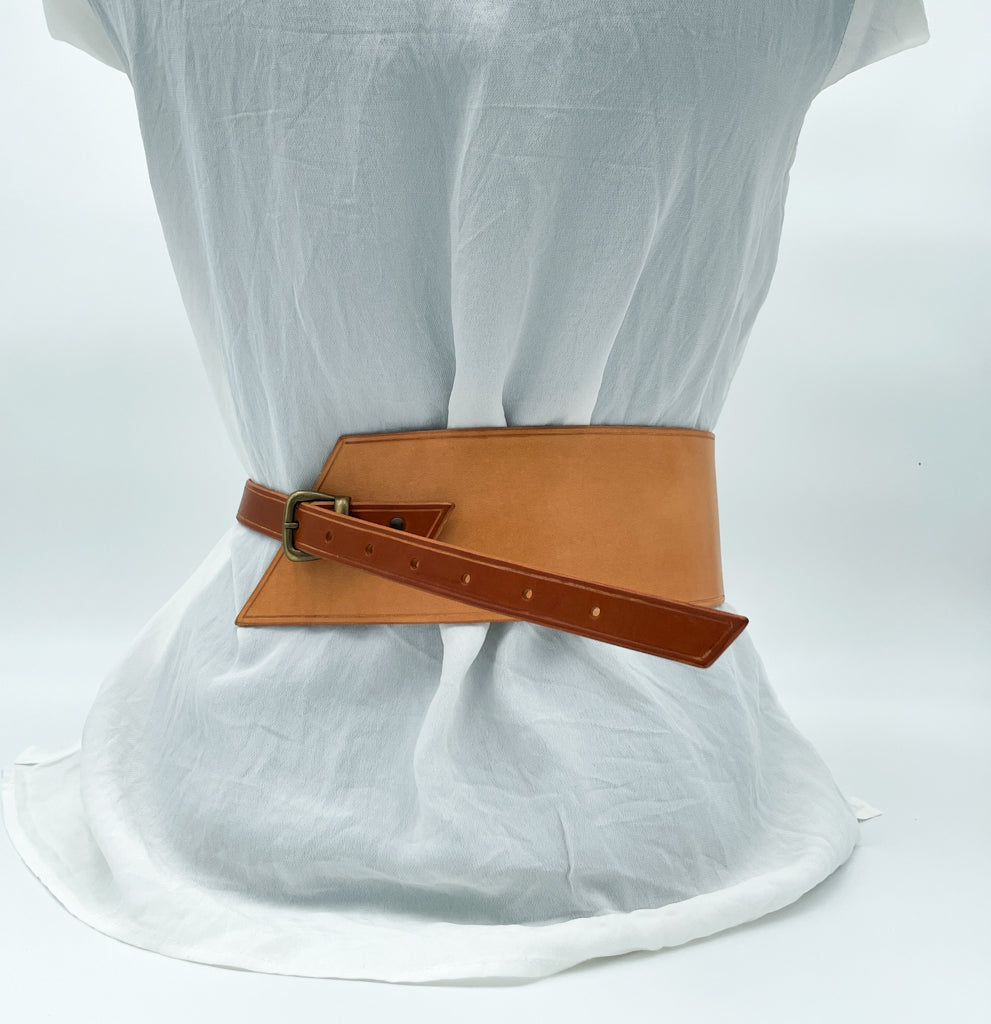 Handmade asymmetrical leather underbust belt with bronze buckles and adjustable strap for the perfect hourglass silhouette