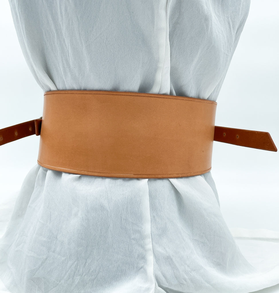 Handmade asymmetrical leather underbust belt with bronze buckles and adjustable strap for the perfect hourglass silhouette