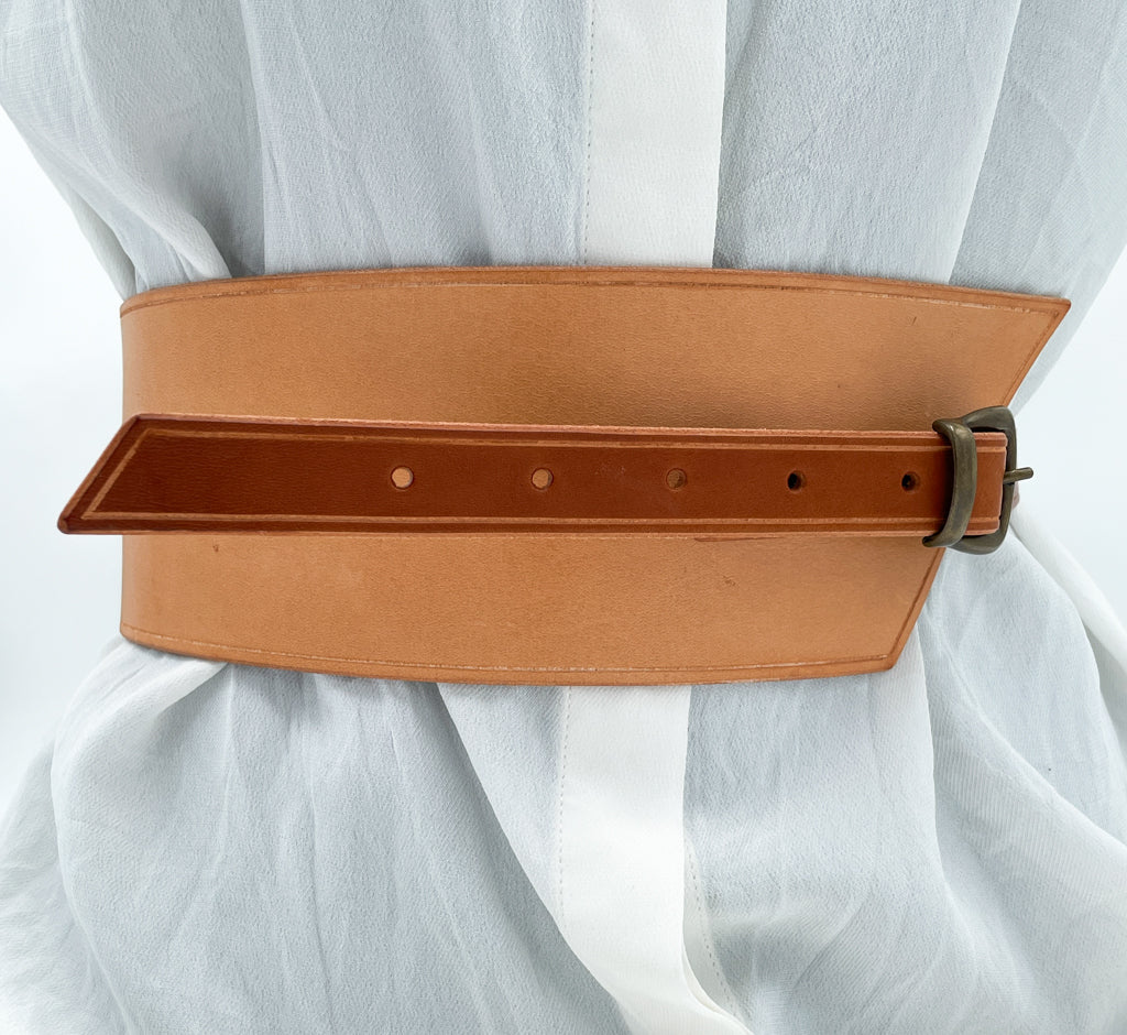 Handmade asymmetrical leather underbust belt with bronze buckles and adjustable strap for the perfect hourglass silhouette