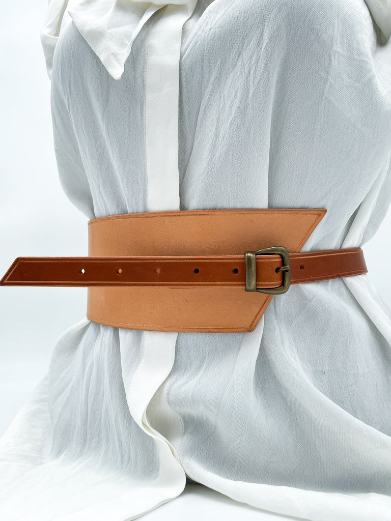 Handmade asymmetrical leather underbust belt with bronze buckles and adjustable strap for the perfect hourglass silhouette